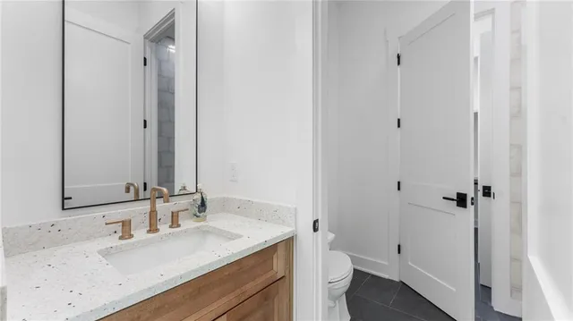 a bathroom with a granite countertop sink toilet and shower