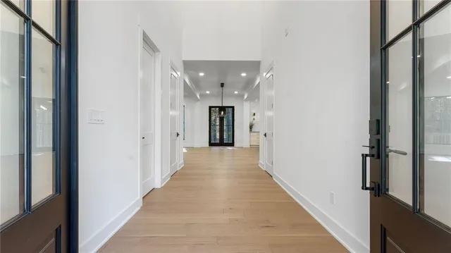 a view of a hallway with wooden floor and staircase
