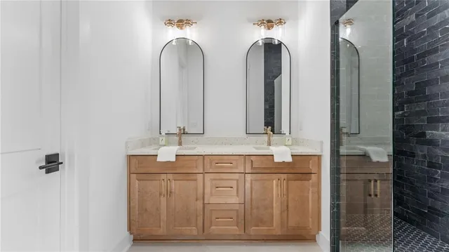 a bathroom with double vanity sinks and a mirror