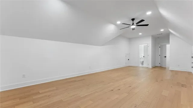 an empty room with an entryway and fan