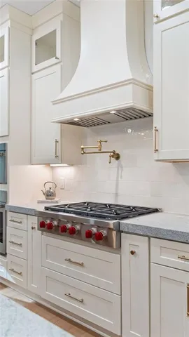 a stove top oven sitting inside of a kitchen