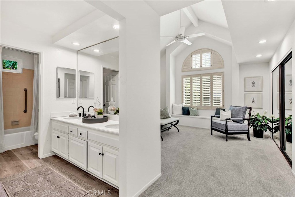 2569 Elden Avenue, Unit A1 Costa Mesa, CA 92627 - Photo 17 of 28 PRIMARE BEDROOM WITH DOUBLE VANITY, VAULTED CEILINGS, AND PLENTY OF NATURAL LIGHT