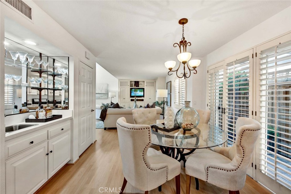 2569 Elden Avenue, Unit A1 Costa Mesa, CA 92627 - Photo 8 of 28 DINING AREA AND WET BAR FOR ENTERTAINING. DOUBLE DOORS TO OUTSIDE WALKWAY