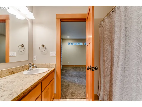a bathroom with a granite countertop sink shower and a mirror