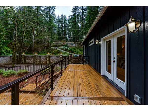 a view of backyard with seating space and wooden fence