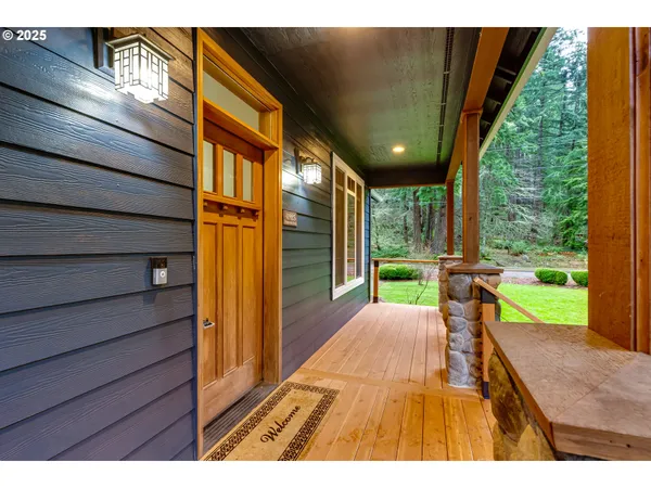 a sitting area with chairs in front of a house