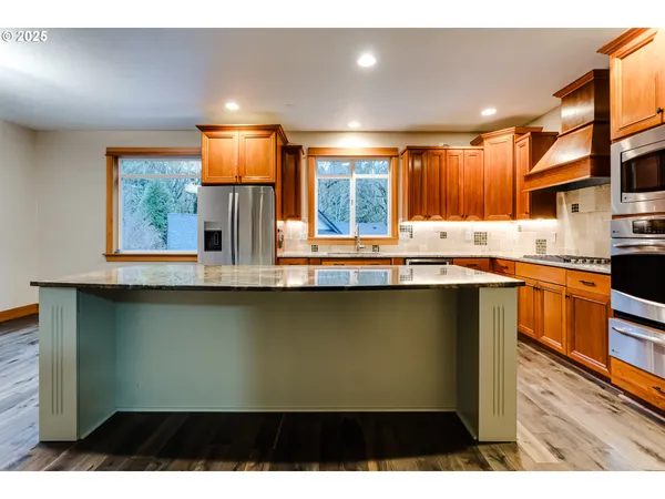 a kitchen with a sink a window and cabinets