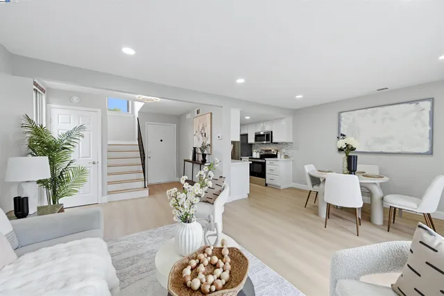 a living room with furniture potted plant and a table