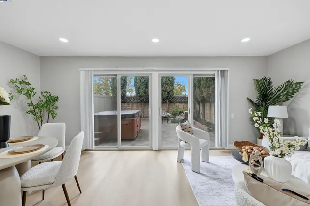a living room with furniture and potted plants
