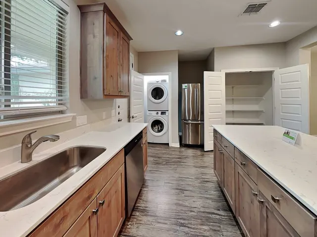 a kitchen with stainless steel appliances granite countertop a sink and cabinets