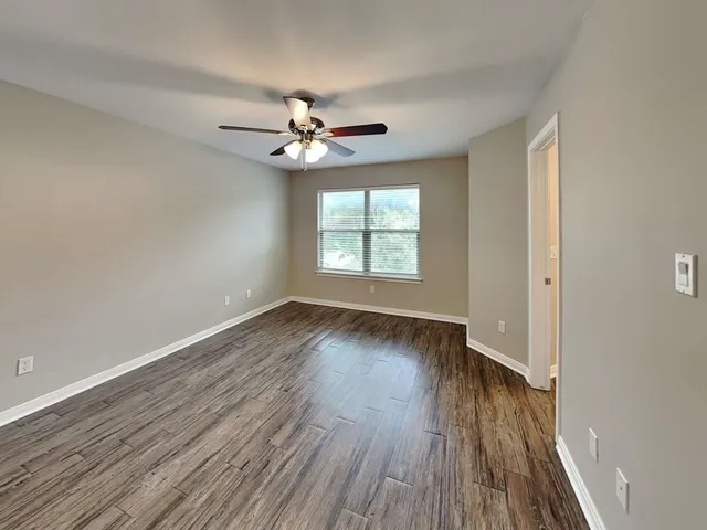 wooden floor in an empty room with a window