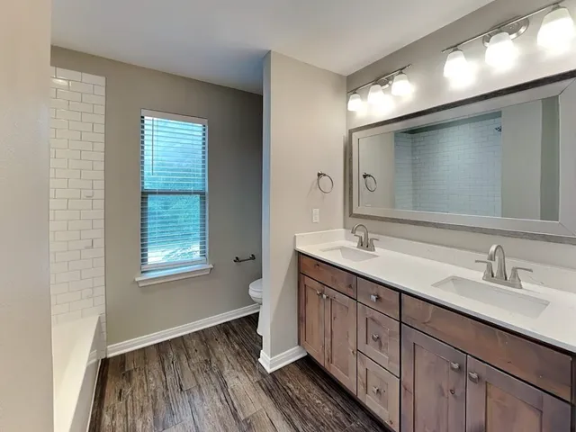 a bathroom with a double vanity sink and a mirror