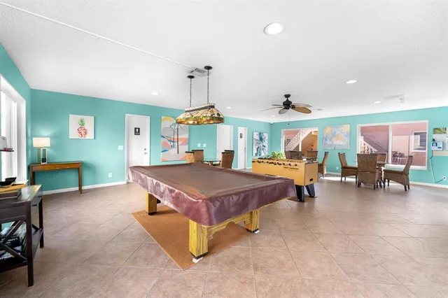 a spacious bedroom with a table a table tennis pool table and chairs