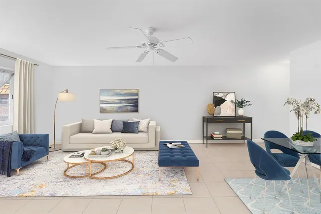 a living room with furniture and a potted plant