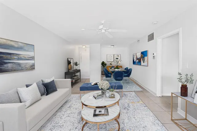 a living room with furniture and a chandelier