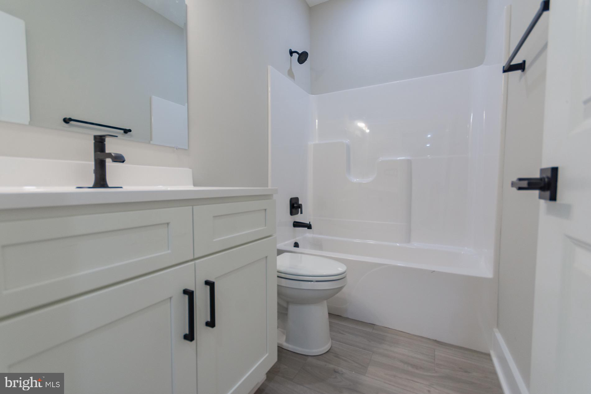 4352 Timber Ridge Road Berkeley Springs, WV 25411 - Photo 32 of 85 a bathroom with a sink a toilet and shower