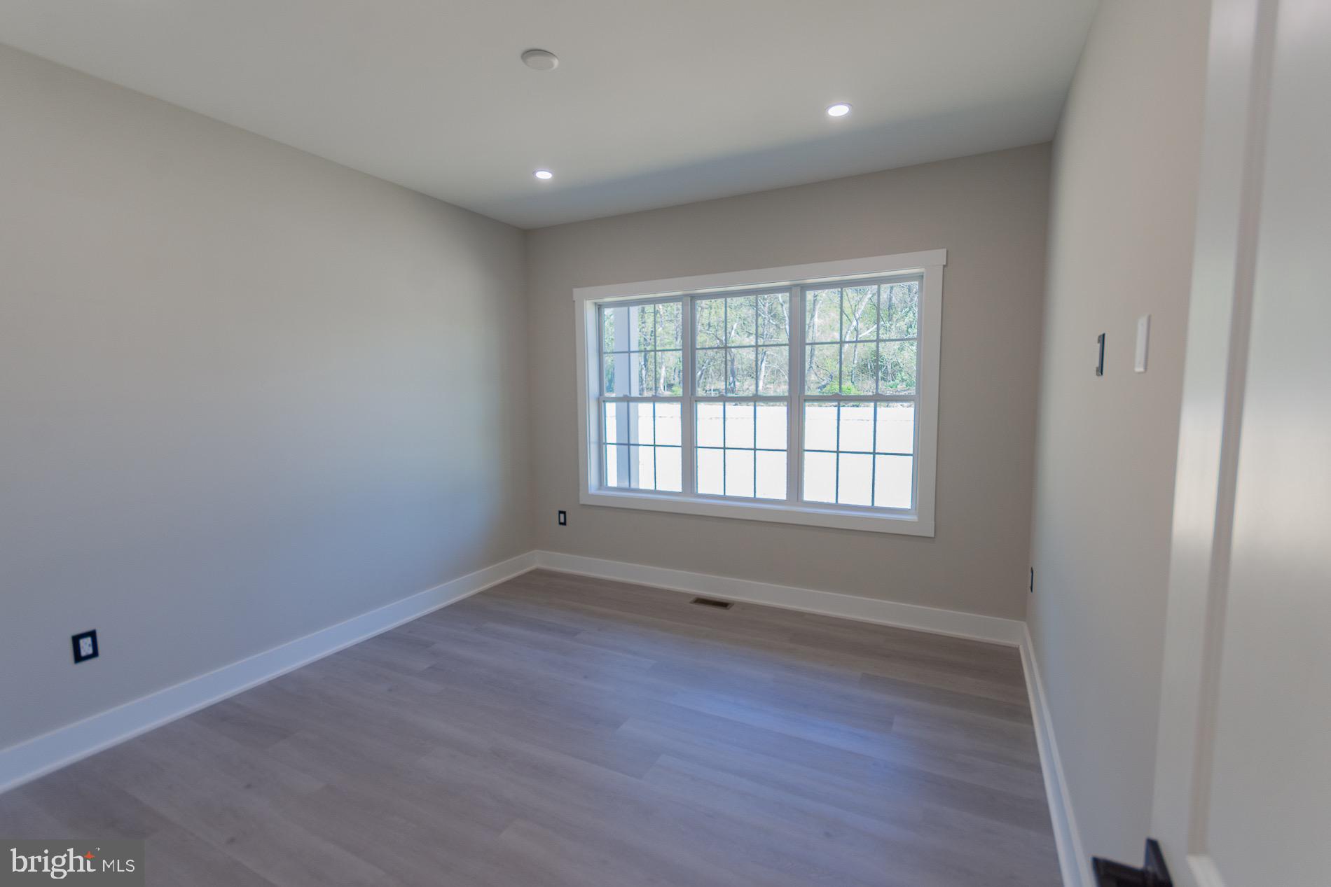 4352 Timber Ridge Road Berkeley Springs, WV 25411 - Photo 33 of 85 an empty room with wooden floor and windows