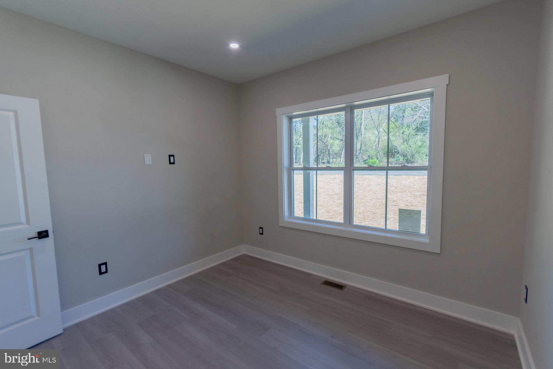 4352 Timber Ridge Road Berkeley Springs, WV 25411 - Photo 40 of 85 an empty room with wooden floor and windows