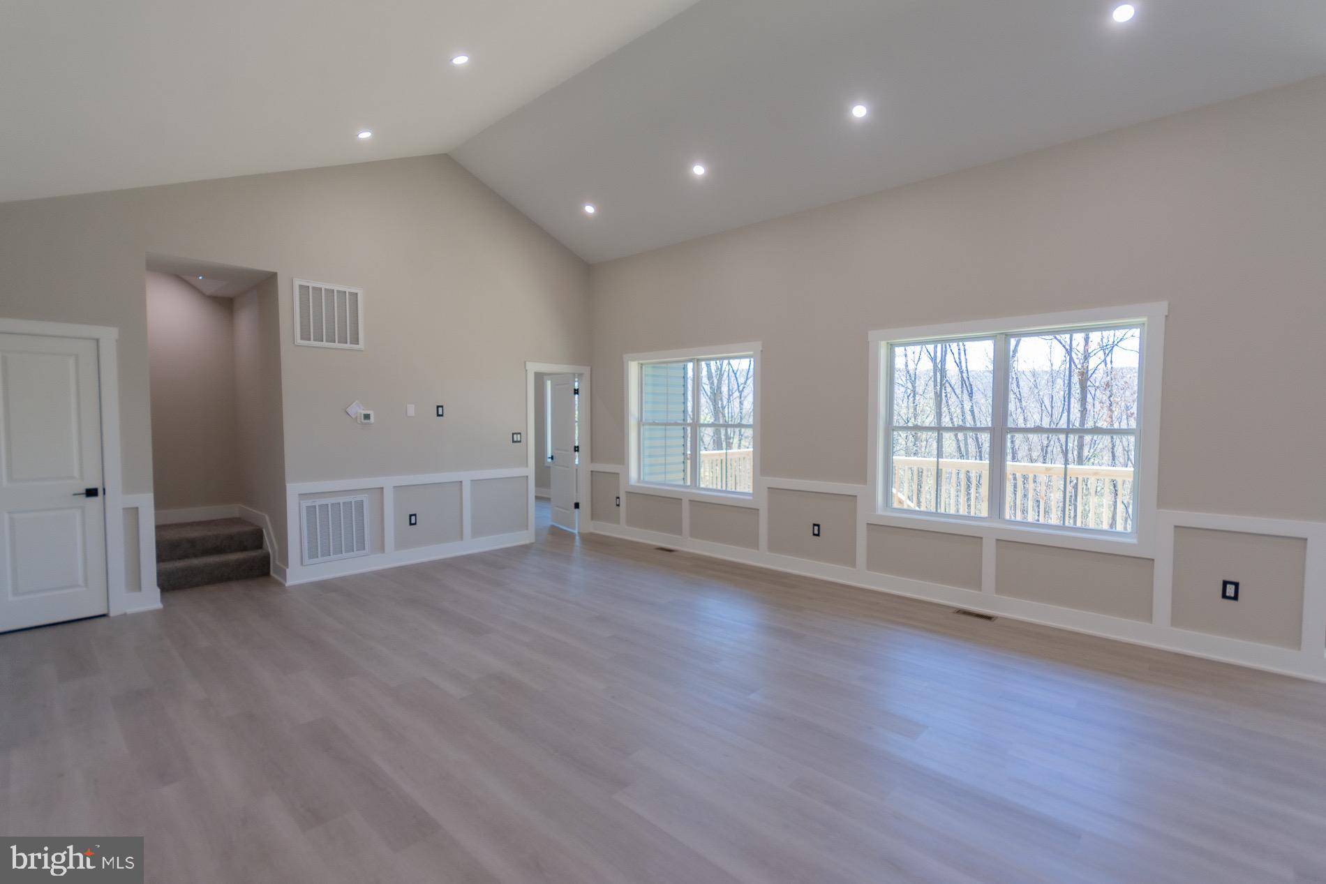 4352 Timber Ridge Road Berkeley Springs, WV 25411 - Photo 45 of 85 an empty room with wooden floor and windows