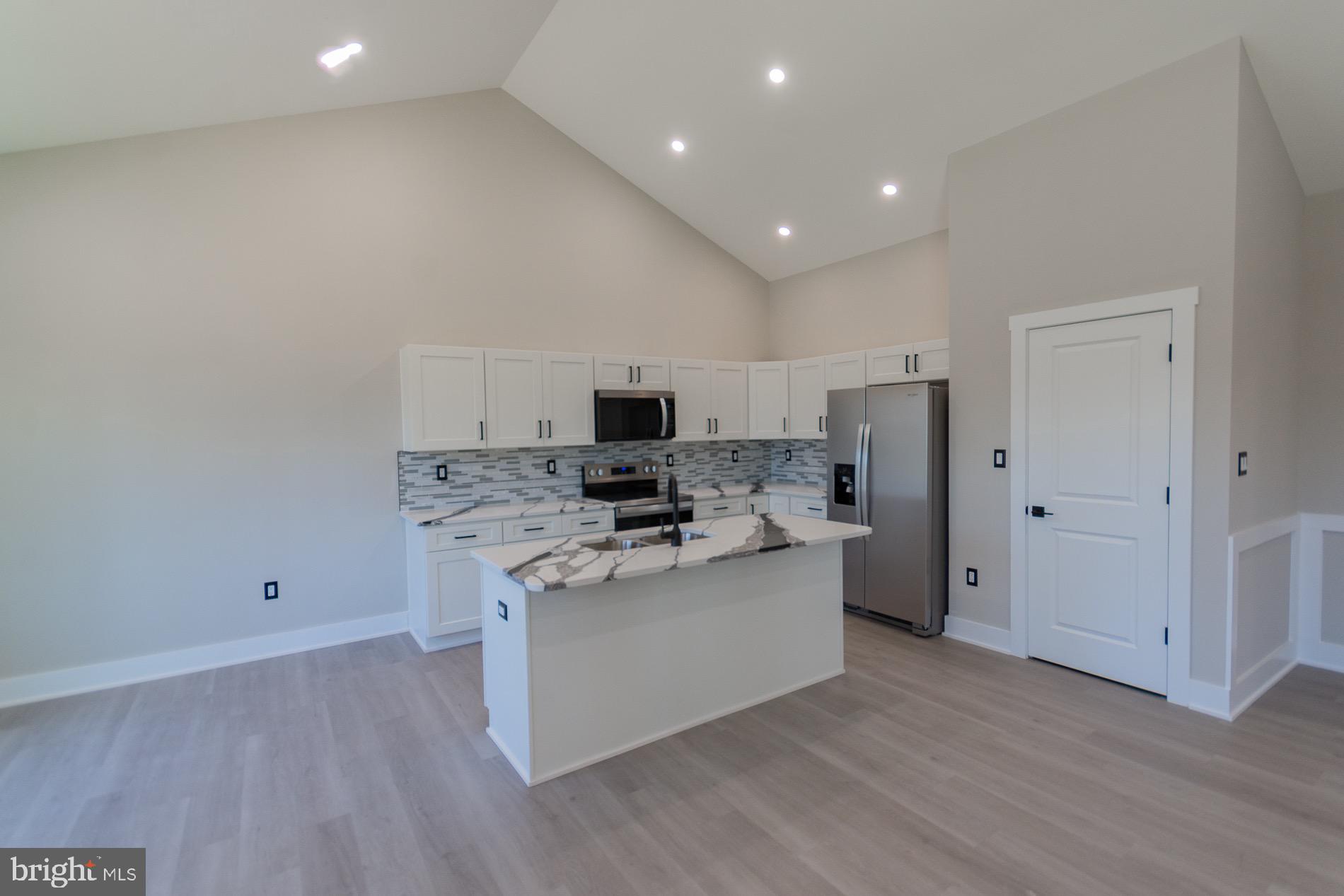 4352 Timber Ridge Road Berkeley Springs, WV 25411 - Photo 47 of 85 a view of a kitchen with a sink and a refrigerator