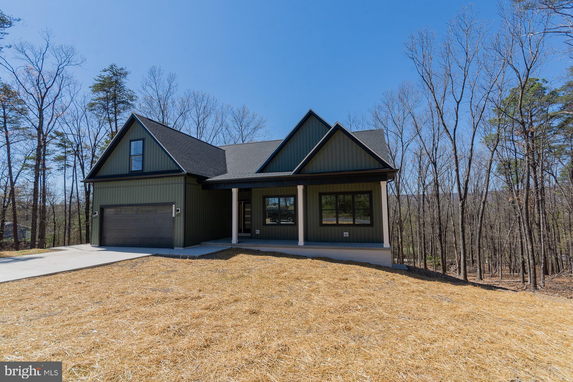 4352 Timber Ridge Road Berkeley Springs, WV 25411 - Photo 5 of 85 a front view of a house with a yard and garage