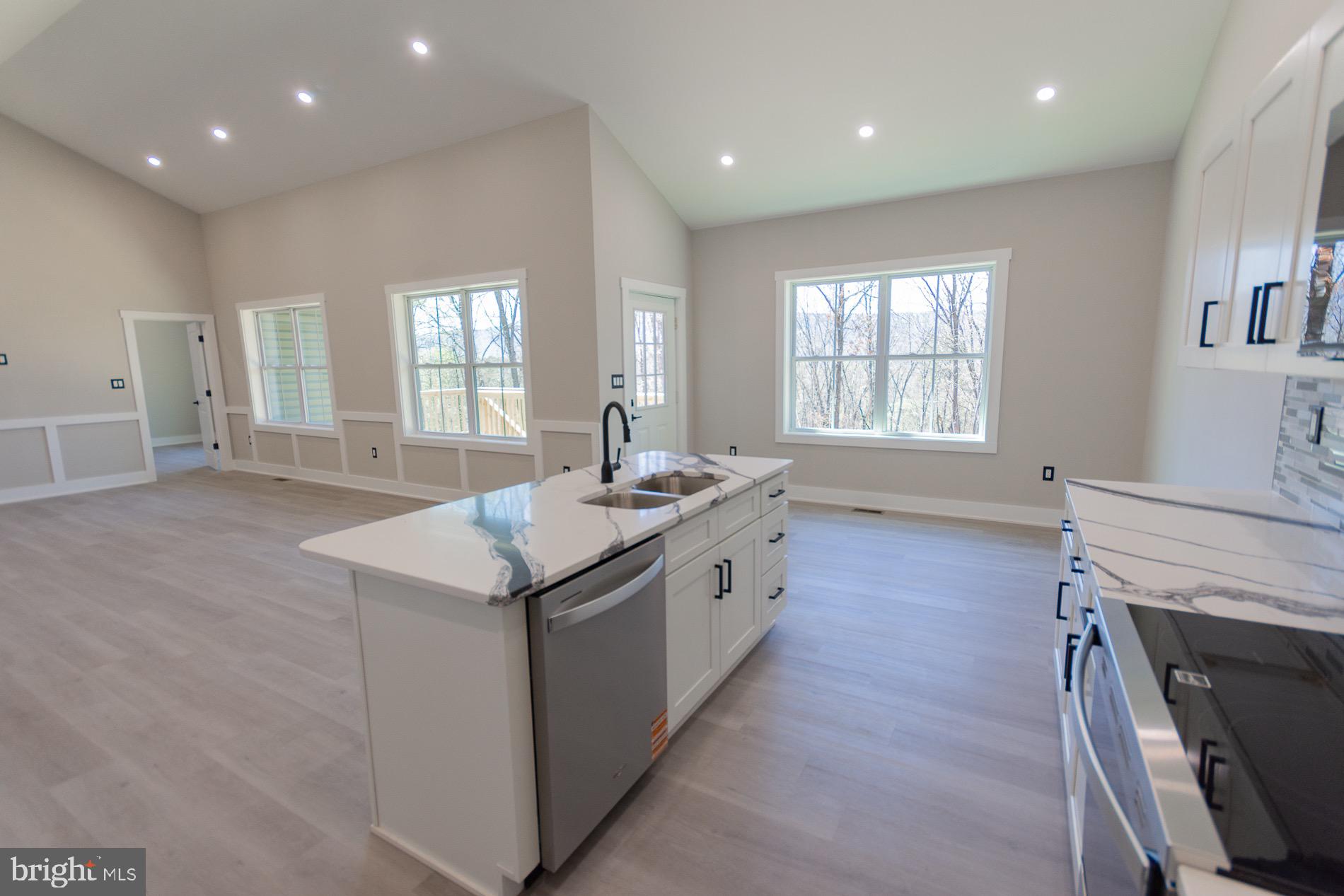 4352 Timber Ridge Road Berkeley Springs, WV 25411 - Photo 53 of 85 a large kitchen with granite countertop a sink and a stove top oven
