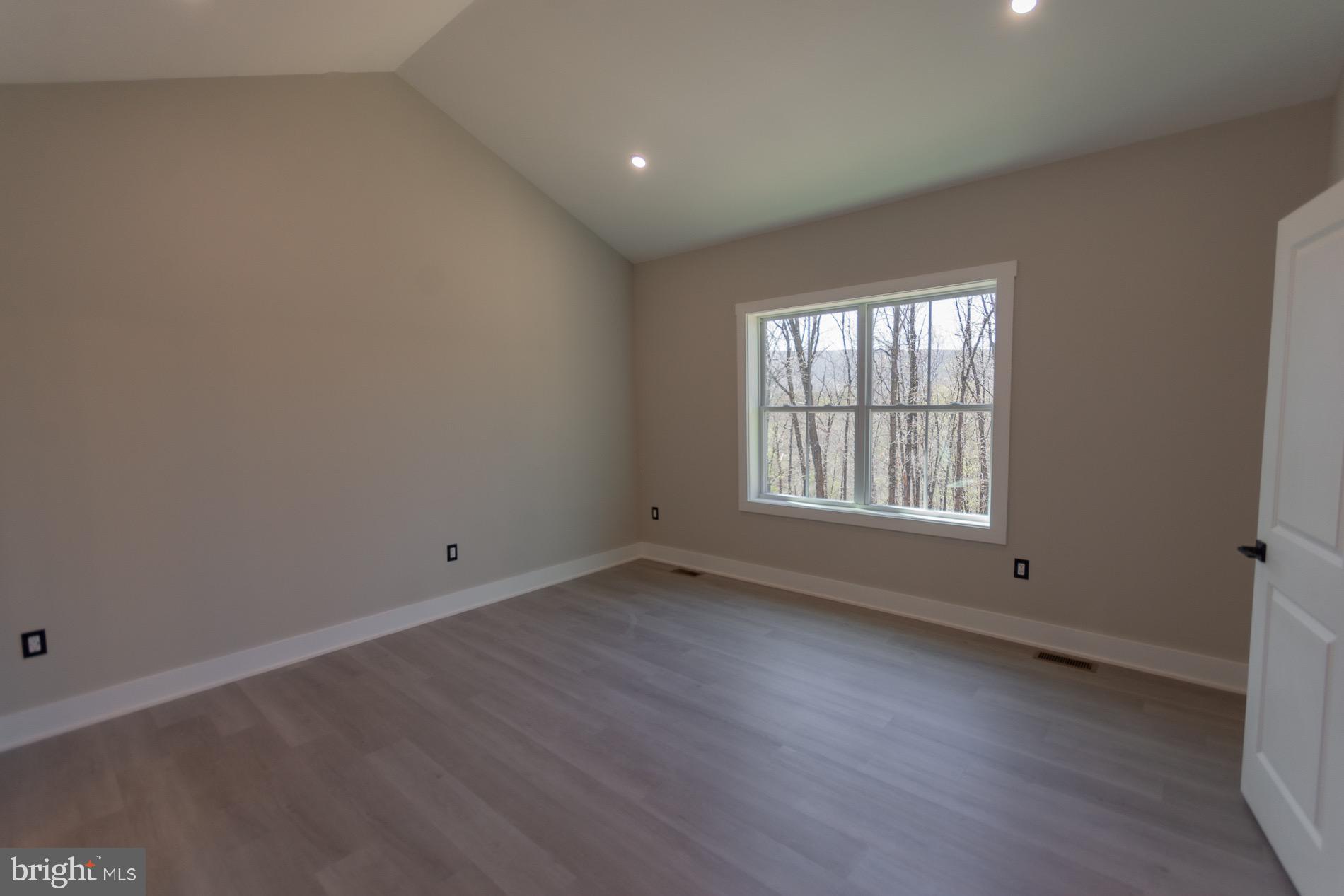 4352 Timber Ridge Road Berkeley Springs, WV 25411 - Photo 56 of 85 an empty room with wooden floor and windows