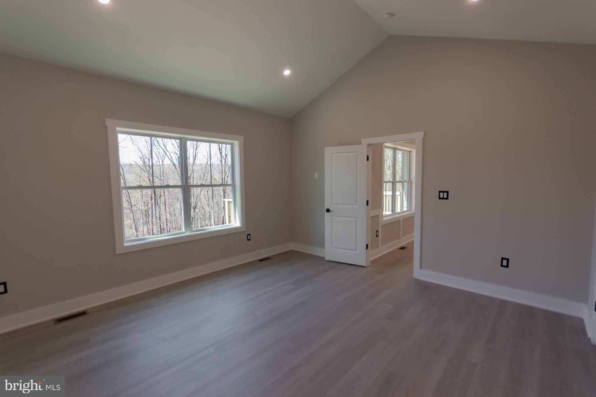 4352 Timber Ridge Road Berkeley Springs, WV 25411 - Photo 57 of 85 an empty room with wooden floor and windows