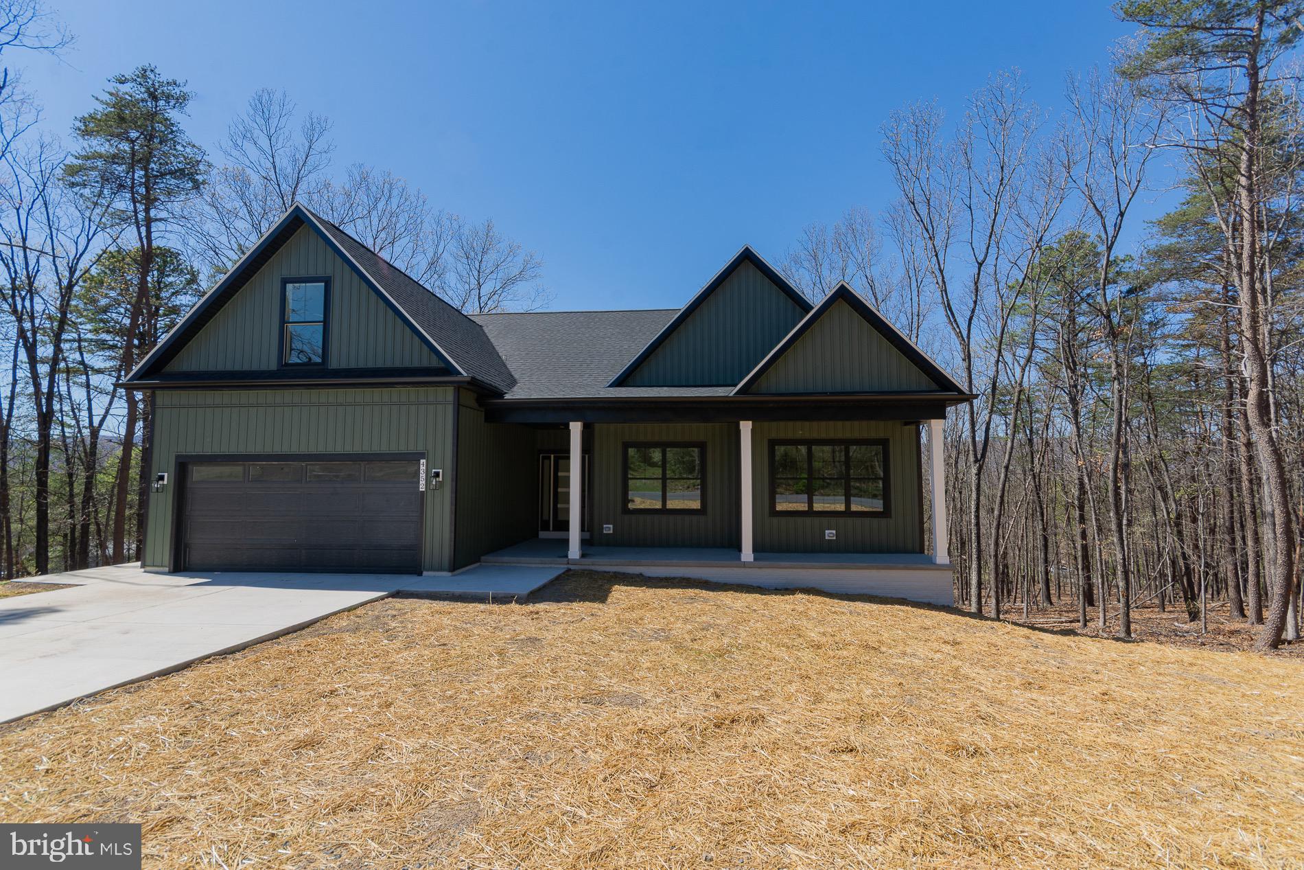 4352 Timber Ridge Road Berkeley Springs, WV 25411 - Photo 6 of 85 a front view of a house with a yard and garage