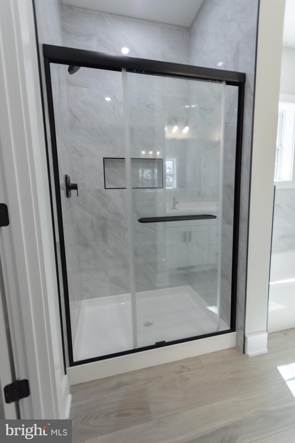 4352 Timber Ridge Road Berkeley Springs, WV 25411 - Photo 64 of 85 a bathroom with a glass shower door and a window