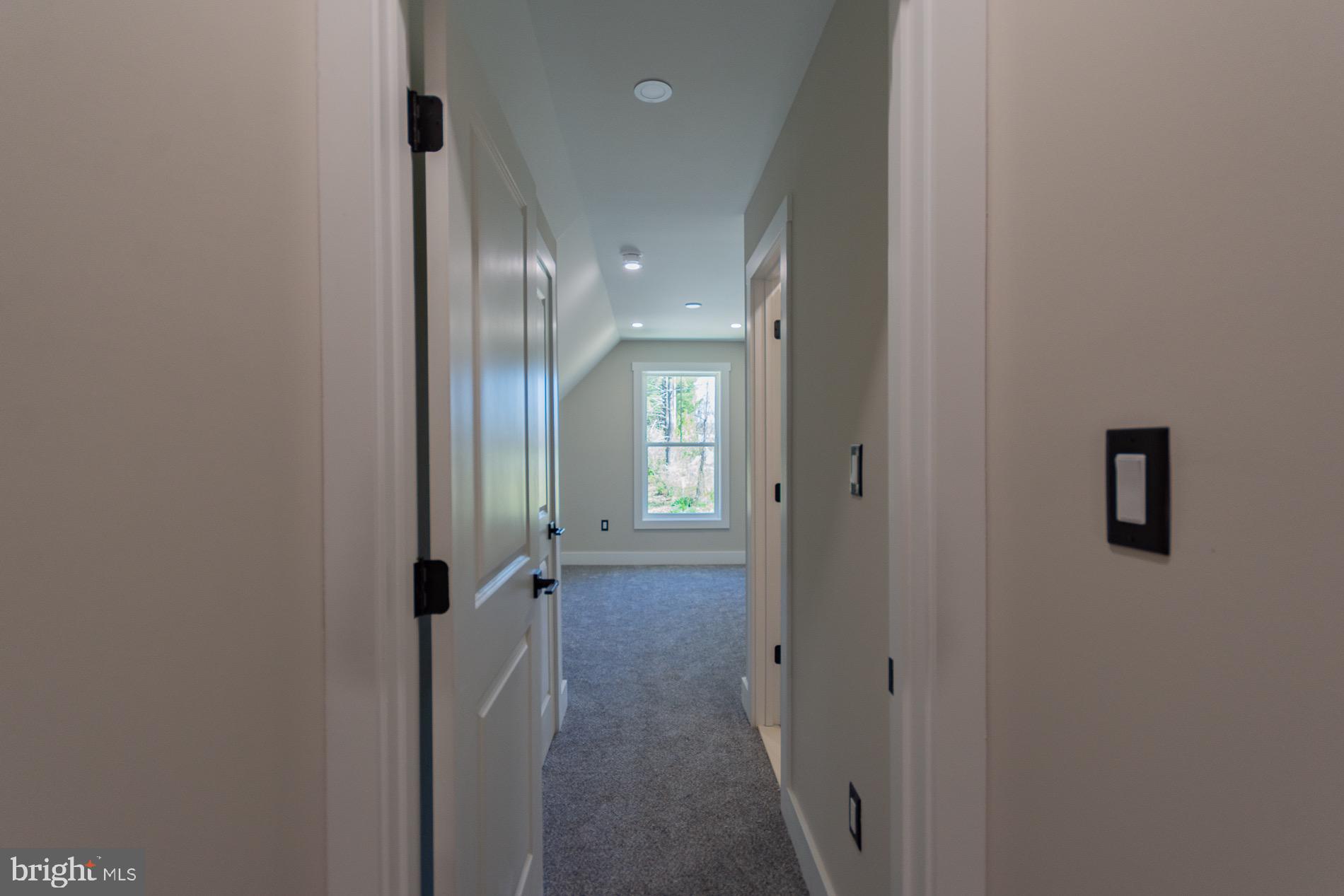 4352 Timber Ridge Road Berkeley Springs, WV 25411 - Photo 66 of 85 a view of a hallway with wooden floor and a bathroom