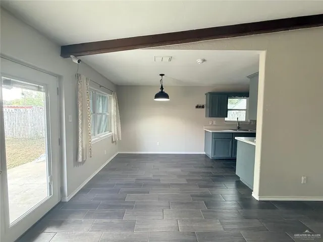 a view of a kitchen with a sink and a large window