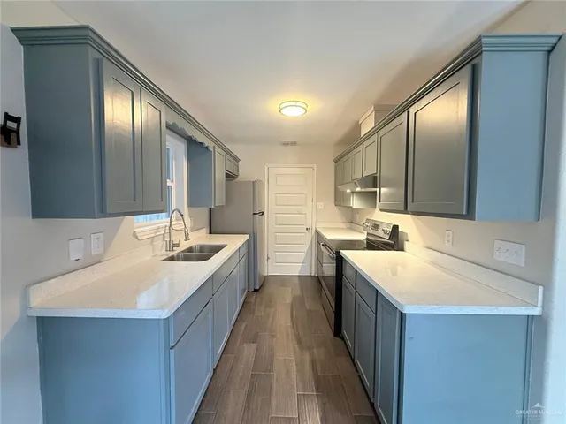 a large white bathroom with a double vanity sink and a mirror