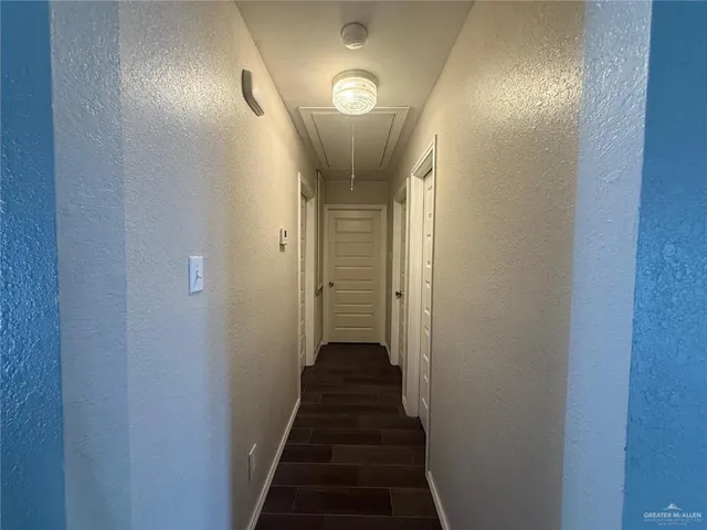 a view of a hallway with wooden floor