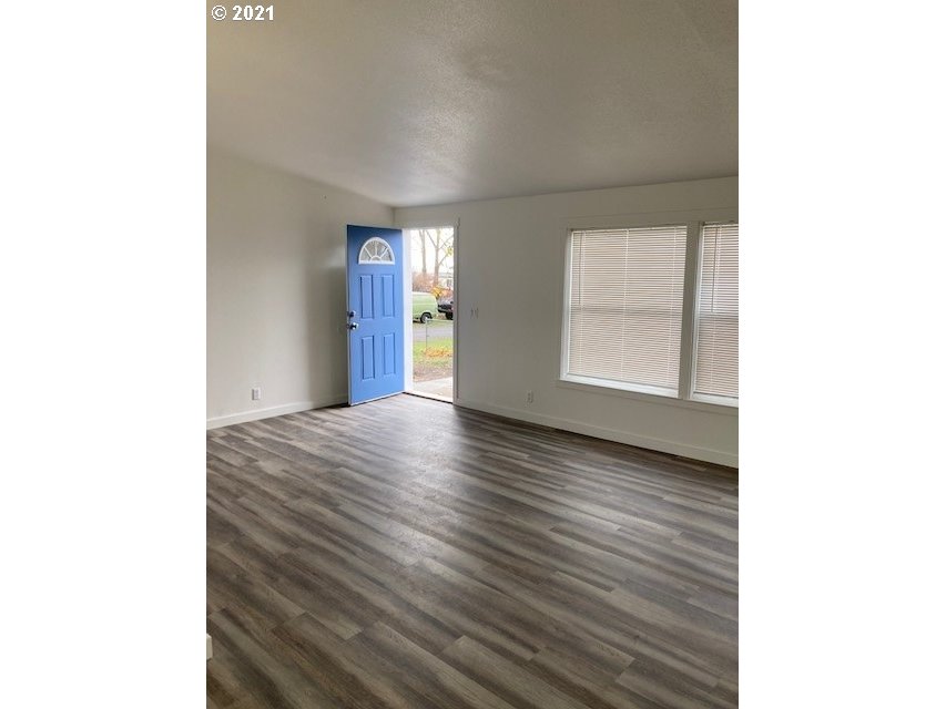 46368 Durham Place Pendleton, OR 97801 - Photo 2 of 32 a view of an empty room with window and wooden floor