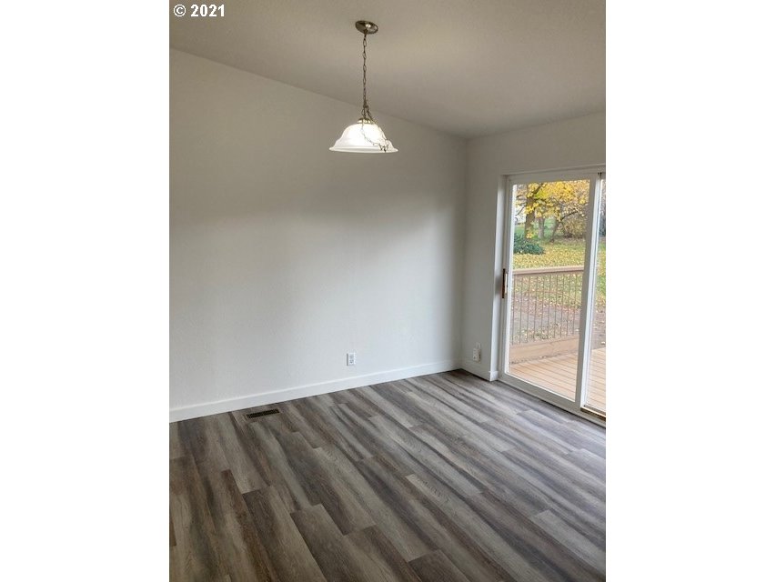46368 Durham Place Pendleton, OR 97801 - Photo 6 of 32 a view of a room with wooden floor and a ceiling fan