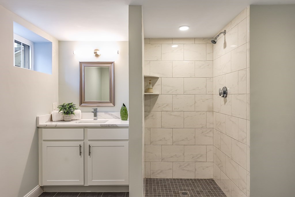 94 Marathon Street, Unit 1 Arlington, MA 02474 - Photo 12 of 24 a bathroom with a sink a toilet a mirror and vanity