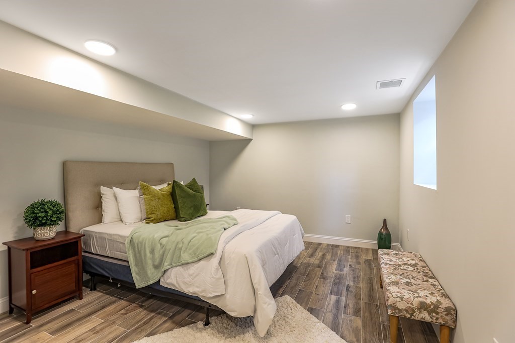 94 Marathon Street, Unit 1 Arlington, MA 02474 - Photo 14 of 24 a bedroom with a bed and a potted plant