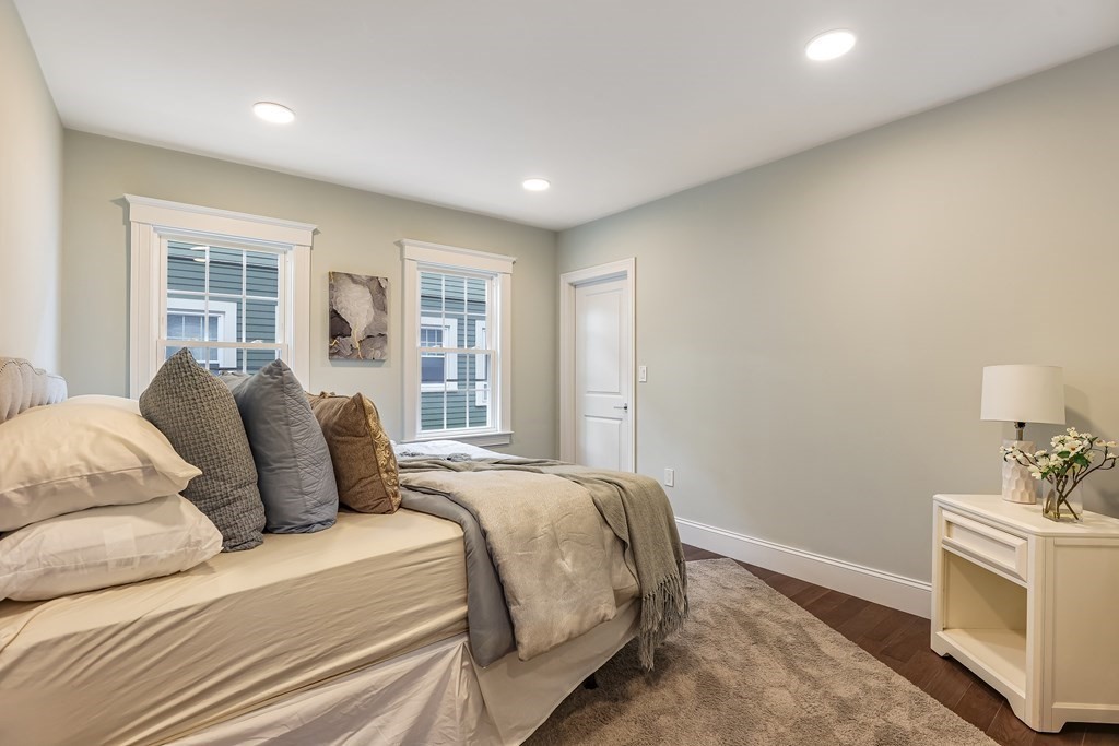 94 Marathon Street, Unit 1 Arlington, MA 02474 - Photo 17 of 24 a bedroom with a large bed and a window