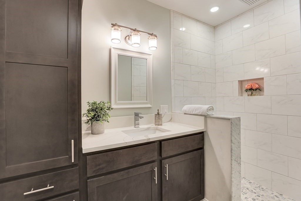 94 Marathon Street, Unit 1 Arlington, MA 02474 - Photo 19 of 24 a bathroom with a sink and a mirror