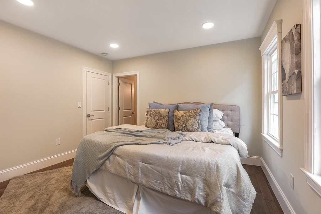 94 Marathon Street, Unit 1 Arlington, MA 02474 - Photo 20 of 24 a large bed sitting in a spacious bedroom next to a window