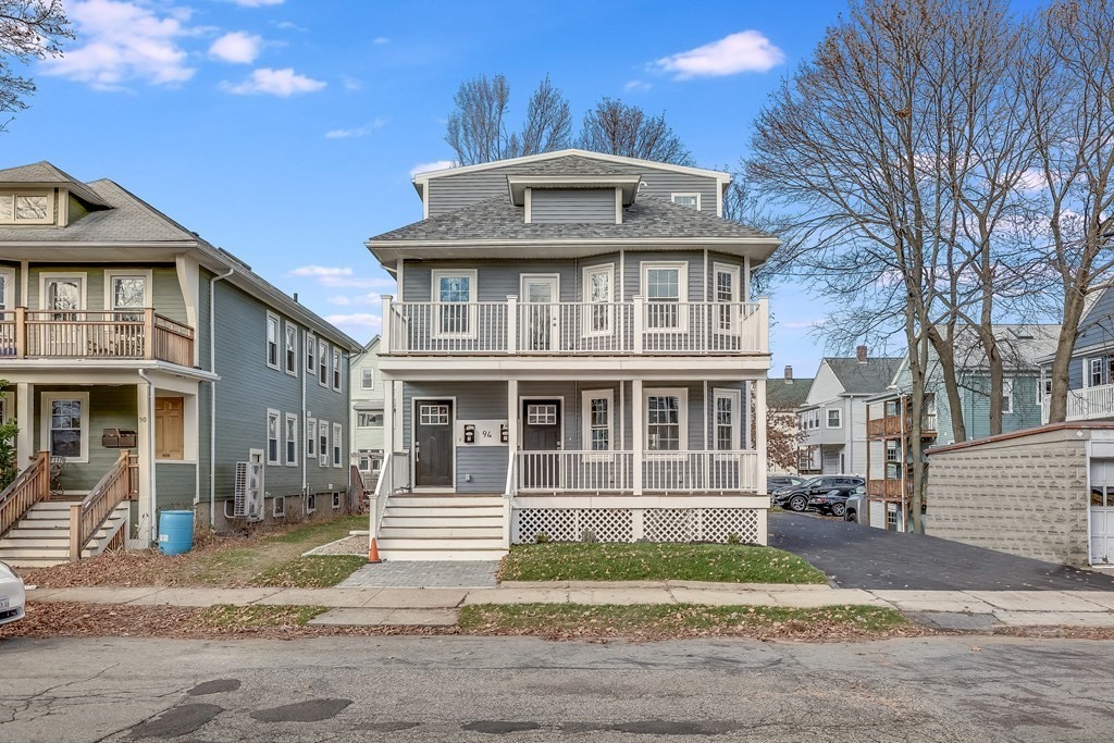 94 Marathon Street, Unit 1 Arlington, MA 02474 - Photo 21 of 24 a front view of a house with a yard