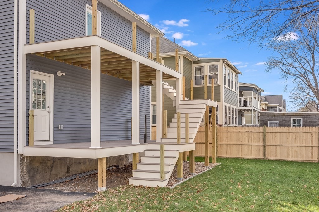 94 Marathon Street, Unit 1 Arlington, MA 02474 - Photo 24 of 24 a front view of a house with a yard and stairs