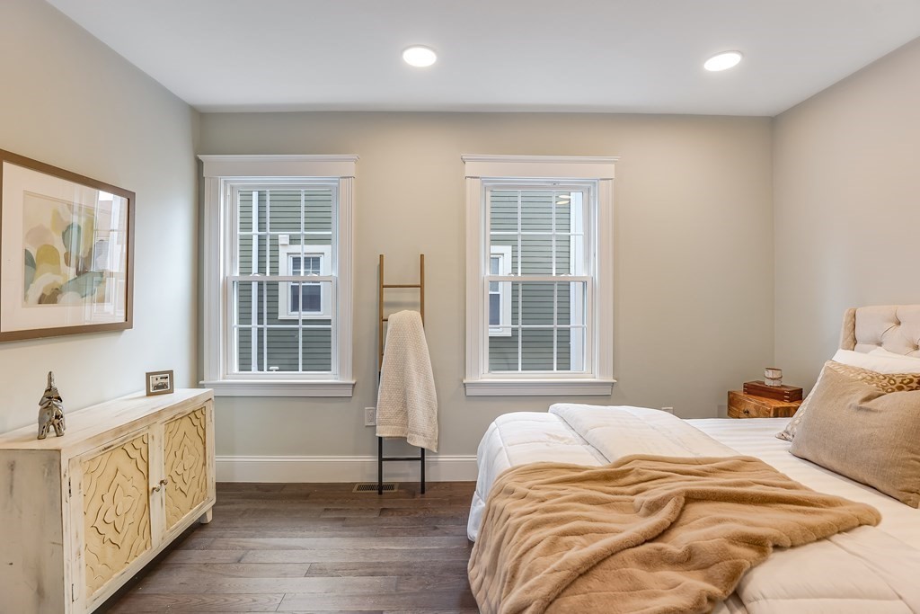 94 Marathon Street, Unit 1 Arlington, MA 02474 - Photo 8 of 24 a bedroom with a bed and a window