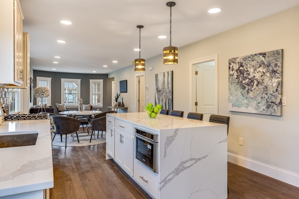94 Marathon Street, Unit 1 Arlington, MA 02474 - Photo 9 of 24 a large kitchen with kitchen island a large island in it