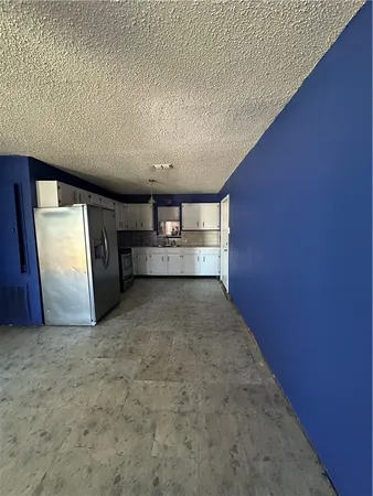 a view of hallway with cabinets