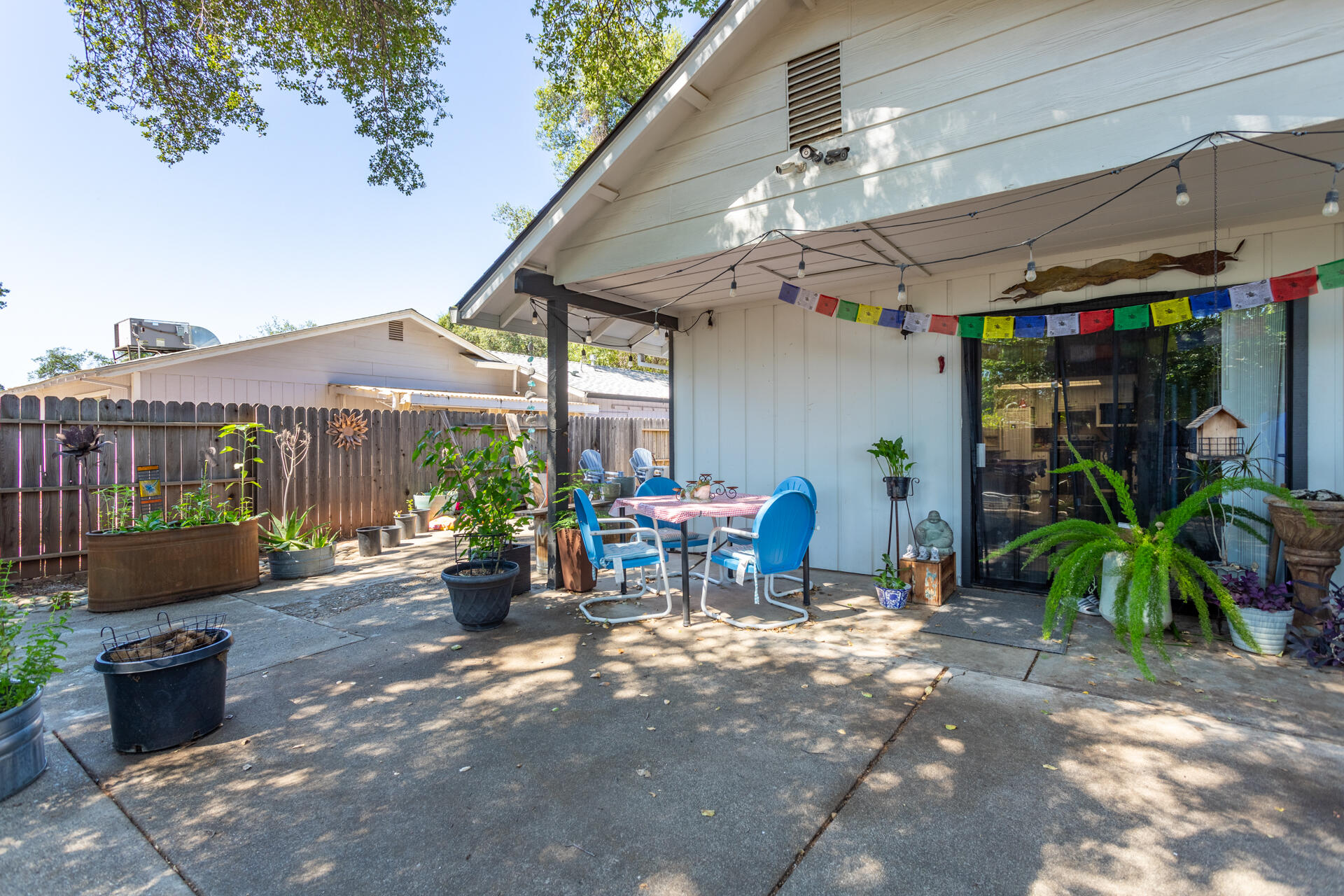 1274 Harpole Road Redding, CA 96002 - Photo 18 of 27 a view of a patio with table and chairs potted plants