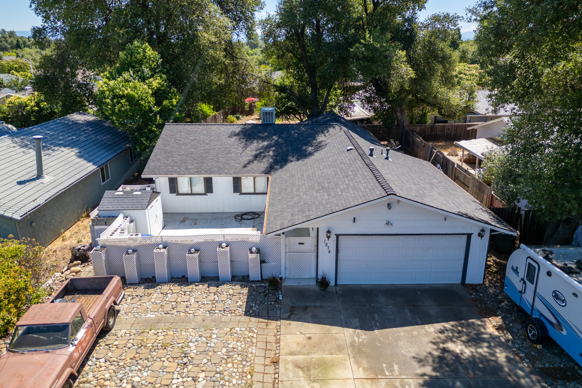1274 Harpole Road Redding, CA 96002 - Photo 2 of 27 a view of a big house with wooden fence next to a road