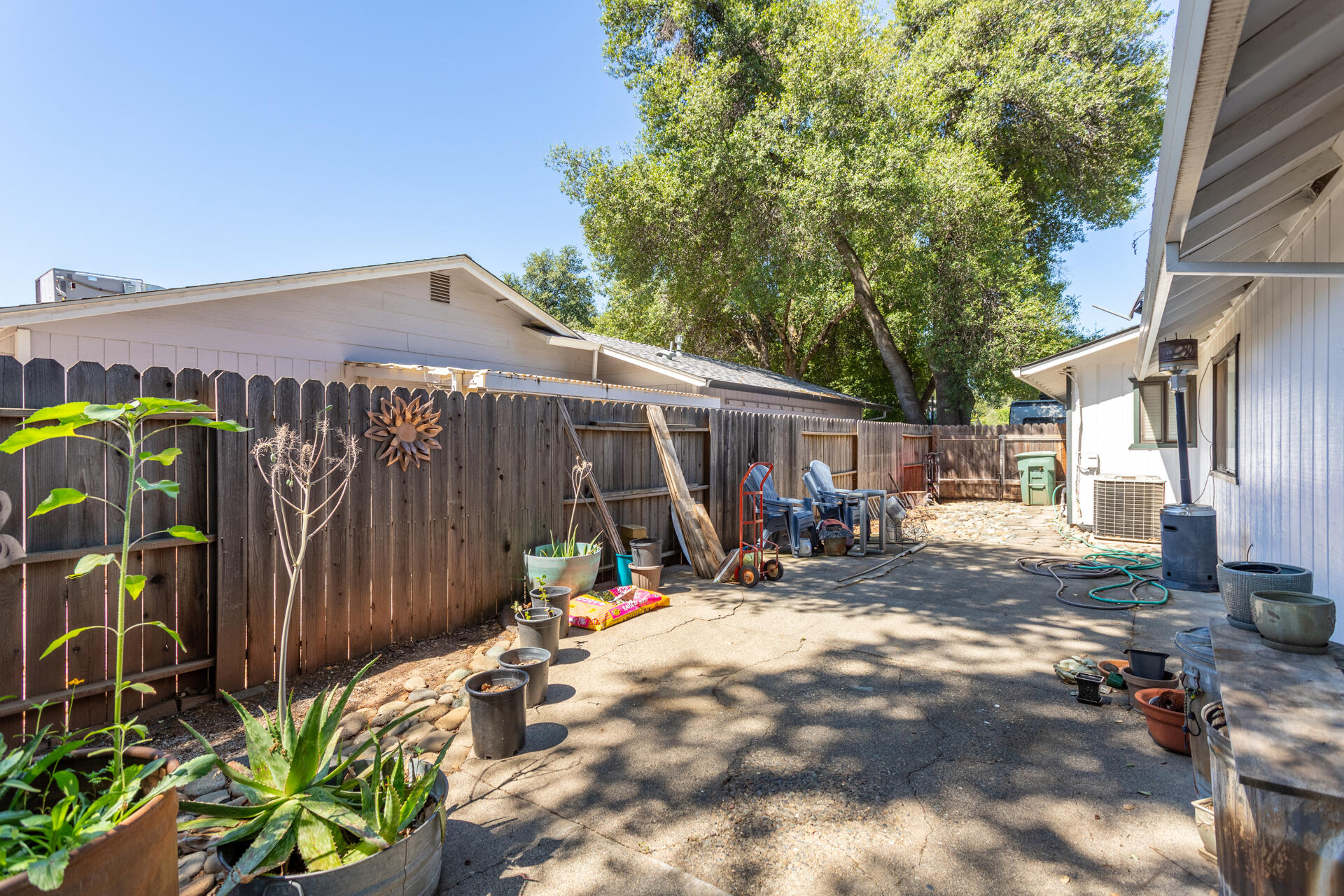 1274 Harpole Road Redding, CA 96002 - Photo 23 of 27 a view of a patio with table and chairs and potted plants
