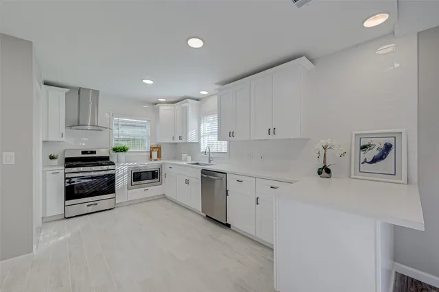 a kitchen with granite countertop white cabinets and white appliances